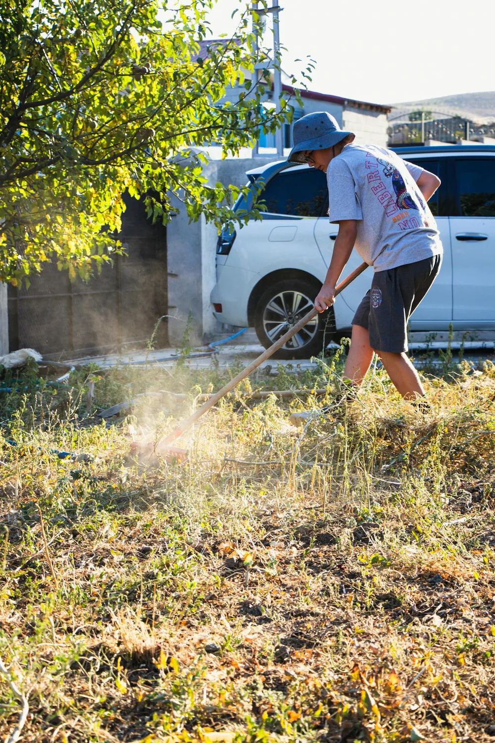 Man raking debris and leaves during spring cleanup